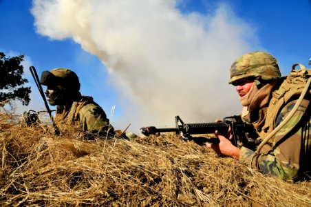US Navy 111008-N-SM578-005 Seabees assigned to Naval Mobile Construction Battalion (NMCB) 40, defend their camp in a simulated firefight
