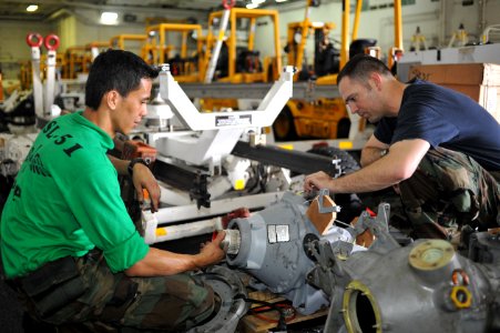 US Navy 111010-N-SF704-064 Aviation Machinist's Mate 2nd Class Richard Madriaga, from La Union, Philippines, left, and Aviation Structural Mechanic photo