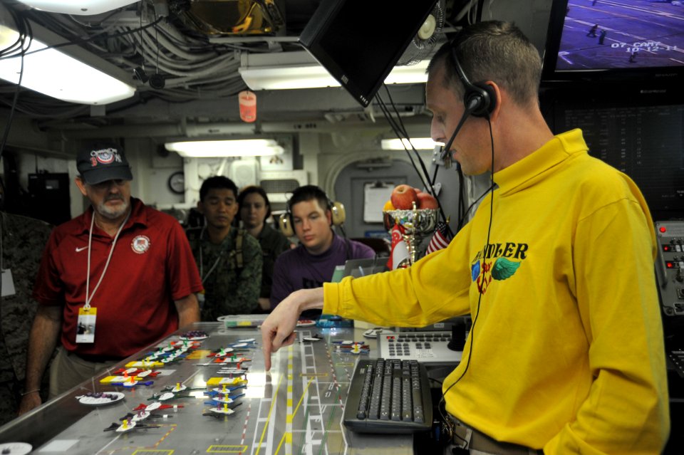 US Navy 111012-N-SF704-312 Lt. Cmdr. Eric Harrington, a flight deck handler aboard the aircraft carrier USS George Washington (CVN 73), discusses s