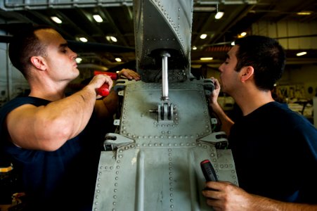US Navy 111011-N-BT887-058 Sailors replace a center stabilizer during a phase B inspection on an MH-60S Sea Hawk helicopter