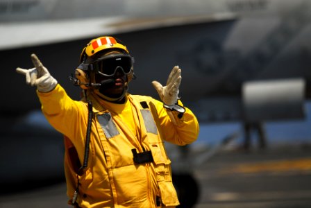 US Navy 111012-N-WW409-245 Senior Chief Aviation Boatswain's Mate (Handling) Glen Newbins directs aircraft on the flight deck of the aircraft carri