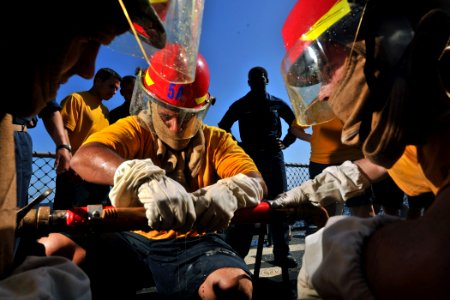 US Navy 111009-N-YZ751-061 Sailors patch a leaking pipe during a damage control Olympics aboard the guided-missile destroyer USS Truxtun (DDG 103)