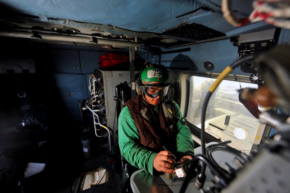 US Navy 111012-N-YZ751-094 Aviation Electronics Technician Airman Raul R. Rodriguez-Peltz programs codes into an MH-60R Sea Hawk helicopter