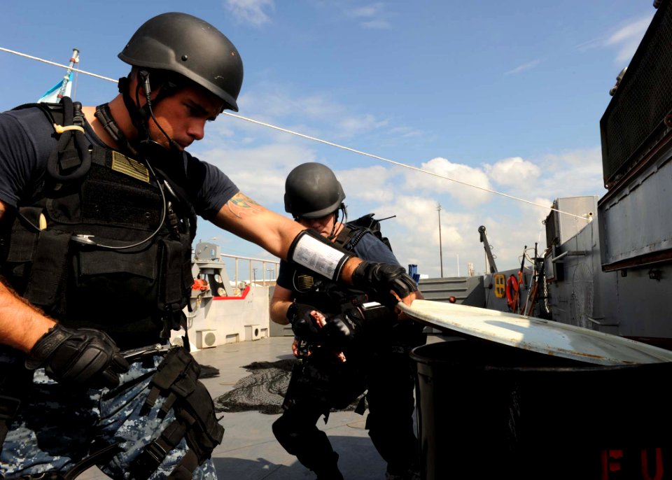 US Navy 111013-N-LX571-295 Sailors assigned to Navy Expeditionary Combat Command (NECC) and the guided-missile cruiser USS Vicksburg (CG 69) board