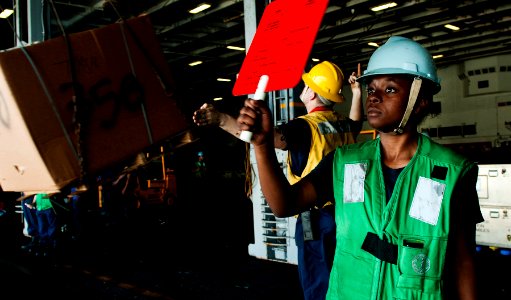US Navy 111013-N-BT887-485 Seaman Chrisma Johnson, from Temple, Texas, signals the Military Sealift Command fast combat support ship USNS Rainier (