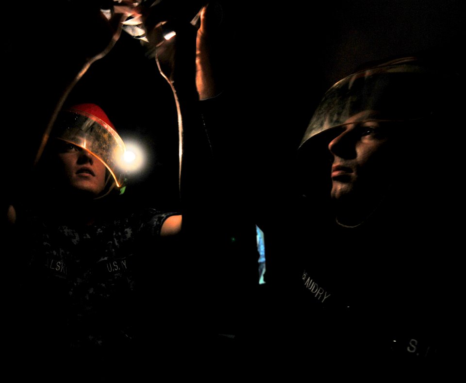 US Navy 111010-N-MW330-115 nformation Systems Technician James Kowalski, left, and Damage Controlman Nicolas Beaudry hang the hose of desmoking equ