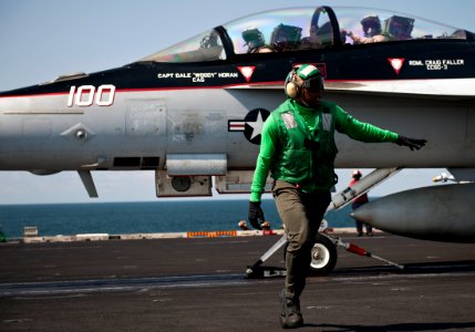 US Navy 111012-N-BT887-135 Aviation Boatswain's Mate (Equipment) 2nd Class Durante Cousins clears the area to launch an F-A-18F Super Hornet