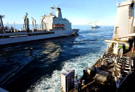 US Navy 111013-N-KS651-191 ervicemembers aboard the amphibious dock landing ship USS Pearl Harbor (LSD 52) watch as Military Sealift Command fleet