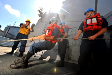 US Navy 111011-N-YZ751-063 Sailors aboard the guided-missile destroyer USS Truxtun (DDG 103) heave a line during a replenishment at sea