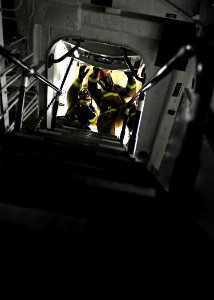US Navy 111011-N-ED900-048 Boundary men raise a hatch to set a smoke boundary during a general quarters drill aboard the Arleigh Burke-class guided