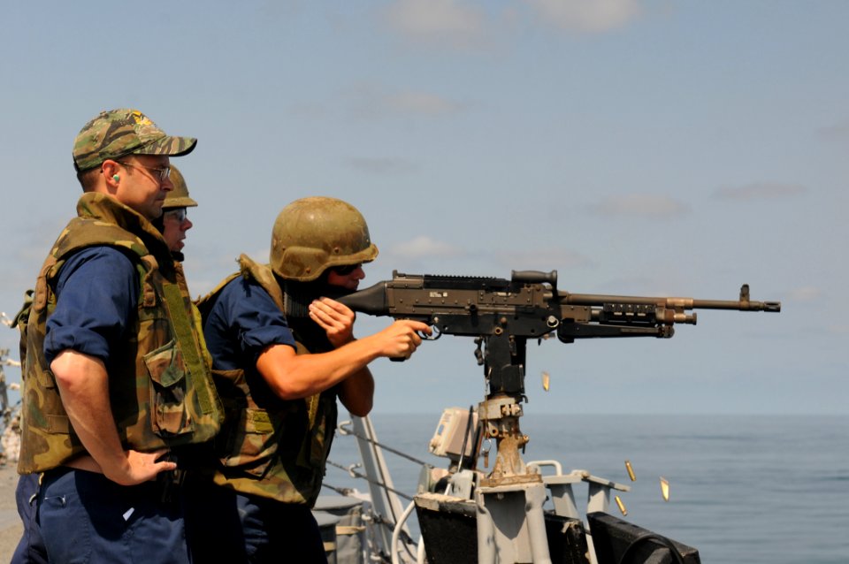 US Navy 111013-N-XQ375-247 Chief Gunner's Mate Richard Randle, left, and Gunner's Mate 2nd Class Stephen Moseley observe as Gunner's Mate 2nd Class