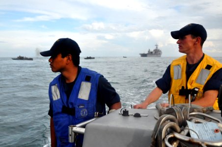 US Navy 111012-N-YX169-383 Engineman Fireman Ian Castil and Boatswain's Mate 3rd Class Christopher Widmar man a 7-meter rigid-hull, inflatable boat