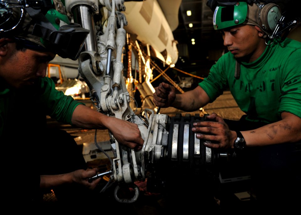 US Navy 111011-N-RJ456-143 Sailors change an axle on the landing gear of an F-A-18C Hornet
