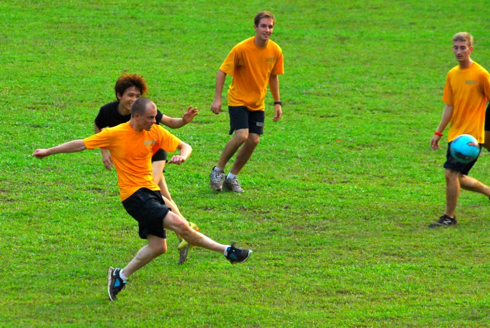 US Navy 111014-N-WW409-229 Fire Controlman 2nd Class Michael Abbott plays soccer with boys and staff members of Boy's Town during a community servi