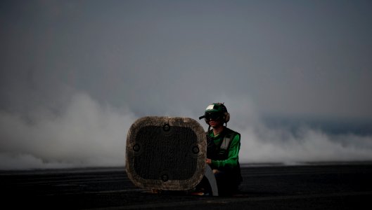 US Navy 111011-N-TU221-383 A Sailor waits to release a catapult between launches aboard the Nimitz-class aircraft carrier USS Abraham Lincoln (CVN photo