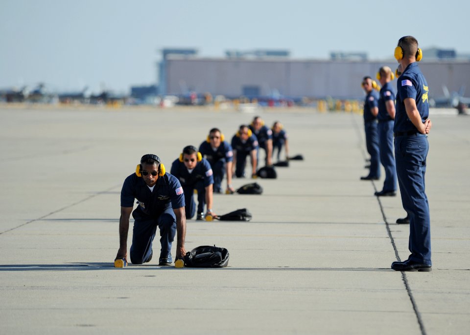 US Navy 111015-N-IR859-047 Members of the U.S. Navy flight demonstration squadron, the Blue Angels, prepare to recover six F-A-18 Hornets