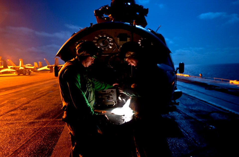 US Navy 111012-N-GC412-079 Aviation Electrician's Mates 2nd Class Jerry Fore, left, and Gerrod Hays re-pin an auto-flight control on an MH-60S Sea