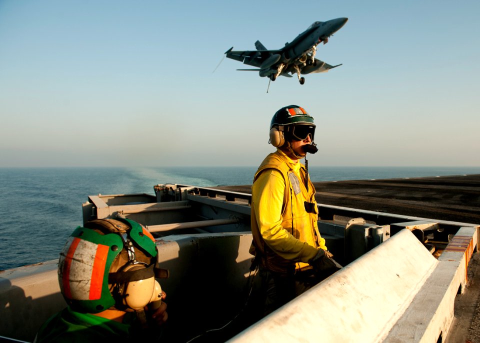 US Navy 111017-N-BT887-404 Lt. Sean Mollahan acts as the arresting gear officer as an F-A-18C Hornet assigned to the Golden Dragons of Strike Fight