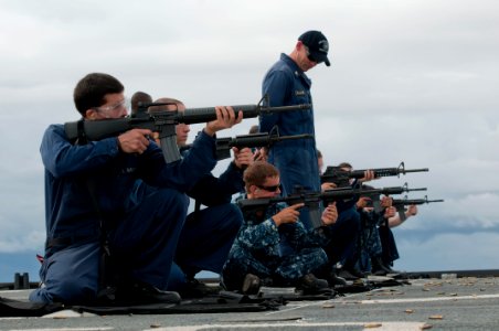US Navy 111017-N-ER662-465 Sailors practice firing M-4 automatic rifles on the flight deck of the amphibious transport dock ship USS Denver (LPD 9)