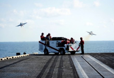 US Navy 111012-N-VN693-285 Sailors stand flight deck fire watch as an F-A-18C Hornet assigned to the Warhawks of Strike Fighter Squadron (VFA) 97 l
