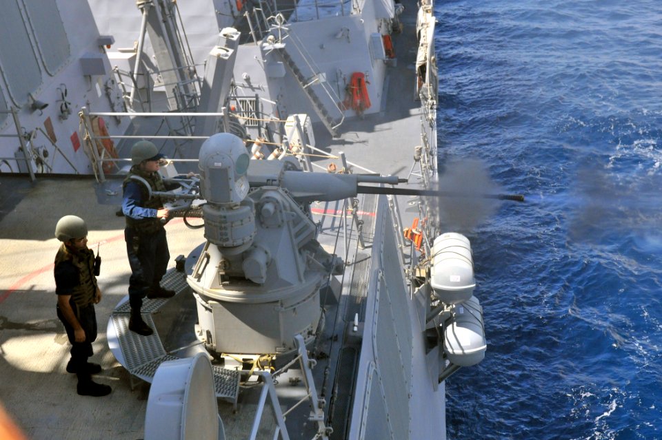 US Navy 111014-N-YZ751-066 Gunner's Mate Seaman Apprentice Lauren C. Hanley fires a MK-38 25 mm machine gun aboard the guided-missile destroyer USS