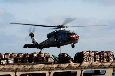 US Navy 111013-N-BT887-016 An MH-60S Sea Hawk helicopter assigned to the Eightballers of Helicopter Sea Combat Squadron (HSC) 8 lifts cargo from th