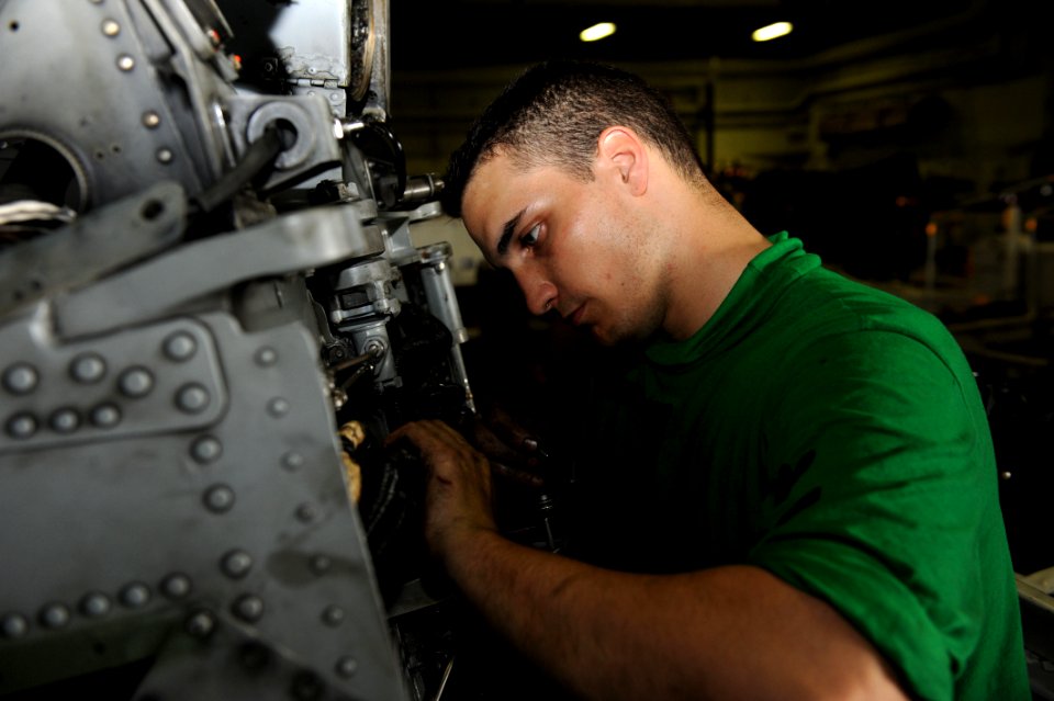 US Navy 111019-N-AU622-015 Aviation Electronics Technician 3rd Class Lee Schneider, from Mansfield, Ohio, performs maintenance on a SH-60H Sea Hawk