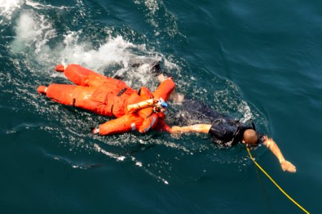 US Navy 111015-N-XQ375-317 Seaman Robert Reynolds, a search and rescue swimmer assigned to the guided-missile destroyer USS Mitscher (DDG 57) photo