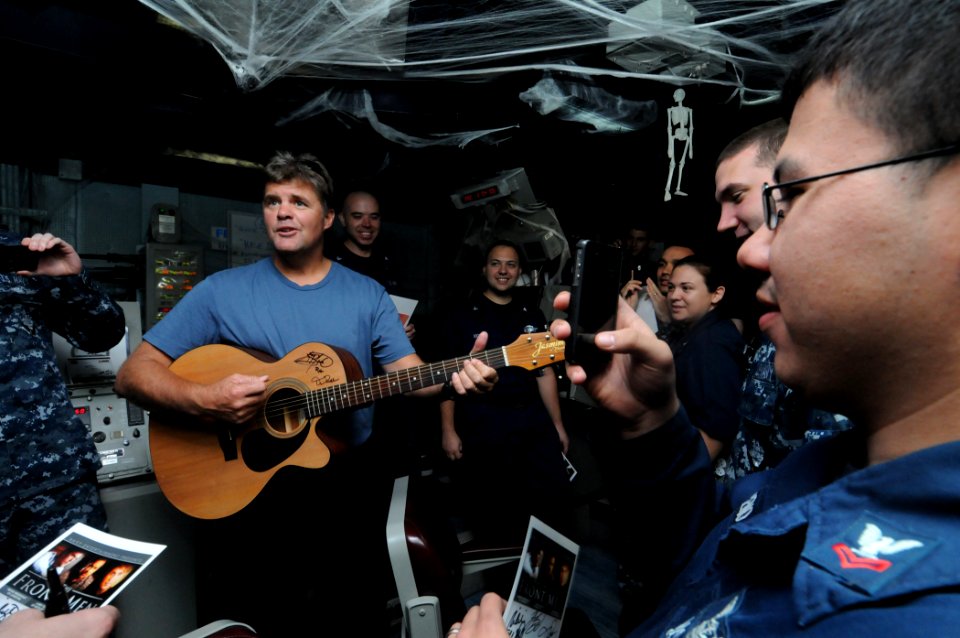 US Navy 111019-N-JD217-075 Richie McDonald, a member of the country music band The Frontmen, plays guitar for Sailors aboard the aircraft carrier U