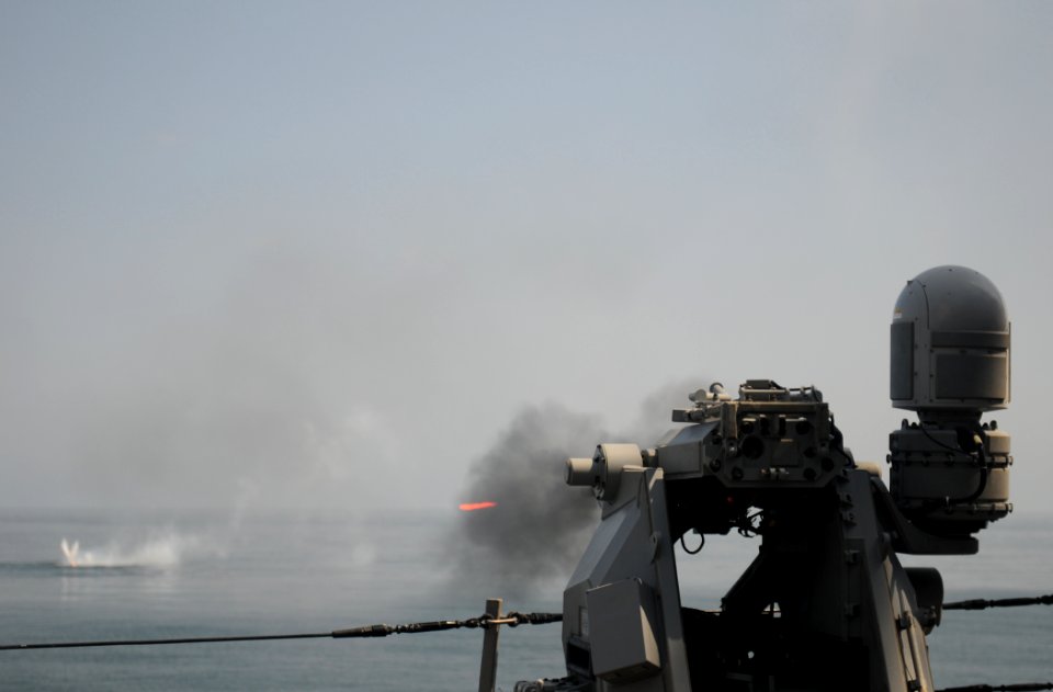 US Navy 111013-N-XQ375-469 A MK-38 25mm machine gun fires during a weapons exercise aboard the guided-missile destroyer USS Mitscher (DDG 57)