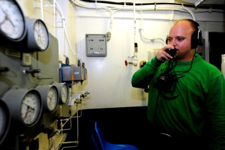 US Navy 111017-N-QL471-041 Aviation Boatswain's Mate (Equipment) Airman Ryan J. Miller reports water brake readings aboard the aircraft carrier USS