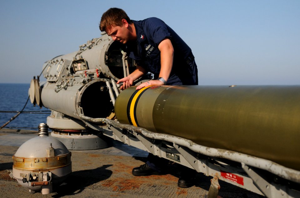 US Navy 111019-N-XQ375-229 Sonar Technician 2nd Class Jesse Lindsey performs maintenance on a MK-32 surface vessel torpedo aboard the guided-missil