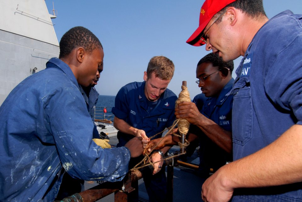 US Navy 111020-N-DU438-069 Damage Controlman 1st Class Peter Martinez instructs Sailors on how to patch a simulated ruptured pipe during a training