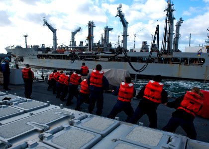US Navy 111019-N-FI736-198 Sailors aboard the guided-missile destroyer USS Arleigh Burke (DDG 51) heave in a line connected to the Military Sealift