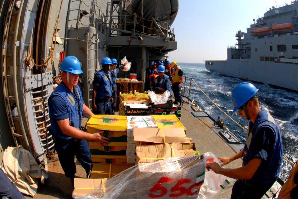 US Navy 111018-N-DU438-350 Sailors unwrap pallets of stores aboard the guided-missile cruiser USS Gettysburg (CG 64) during a connected replenishme