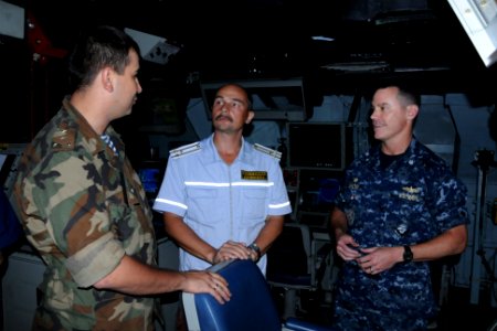 US Navy 111015-N-UE250-302 Russian Group Ship Commodore Sergey Jzuga talks with Cmdr. Steven DeMoss, commanding officer of the Arleigh Burke-class