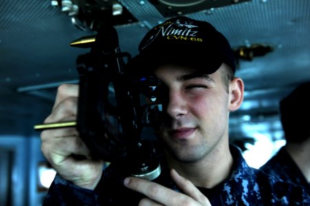 US Navy 111020-N-OY799-030 Quartermaster Seaman Tyler Shear, from Grand Rapids, Mich., uses a stadimeter on the bridge aboard the Nimitz-class airc