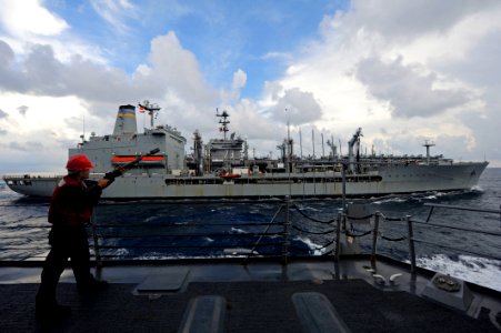 US Navy 111020-N-VH839-014 Gunner's Mate 2nd Class Nelson Sanchez shoots a shot-line to the Military Sealift Command fleet replenishment oiler USNS