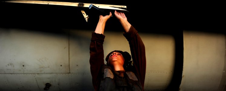 US Navy 111016-N-VN693-381 Aviation Structural Mechanic Airman Morgan Angle, from Rockford, Mich., secures the ladder on an F-A-18C Hornet assigned