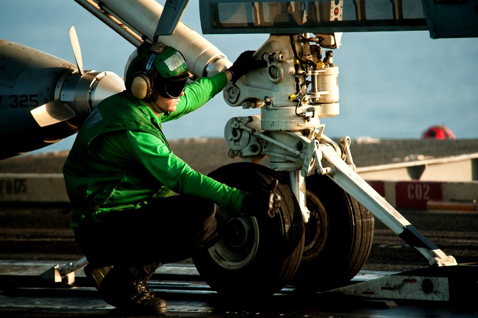 US Navy 111017-N-BT887-366 Aviation Boatswain's Mate (Equipment) Airman Adam Fitzgerald gives a thumbs up before performing a final check on an F-A