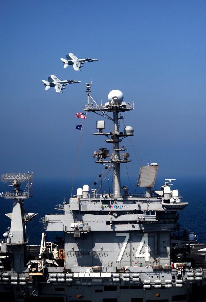 US Navy 111017-N-VN693-525 Two F-A-18C Hornets assigned to the Golden Dragons of Strike Fighter Squadron (VFA) 192 fly over the aircraft carrier US