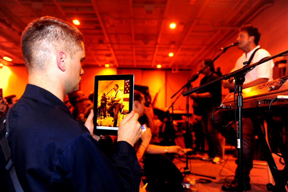 US Navy 111019-N-QL471-638 Logistics Specialist 3rd Class Robert W. Moye records video of the country music band The Frontmen aboard the aircraft c
