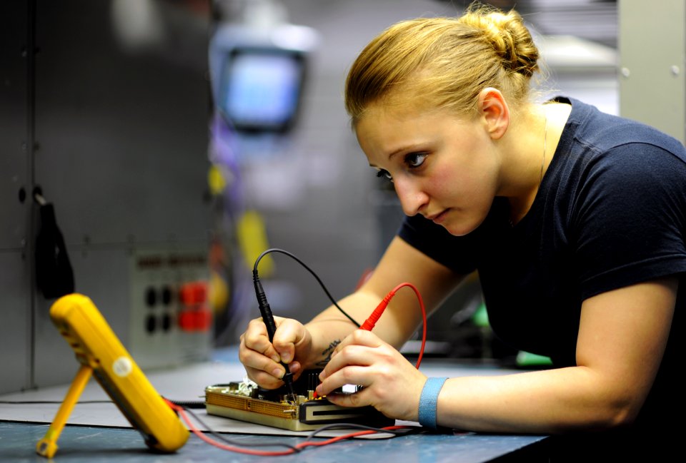 US Navy 111021-N-XE109-186 Aviation Electronics Technician Airman Cristina N. Mace tests resistors on a circuit card aboard the aircraft carrier US