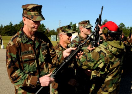 US Navy 111020-N-SN160-009 Rear Adm. Mark Handley and Capt. Frederick Burgess clear their weapons before an M16-M4 service rifle qualification