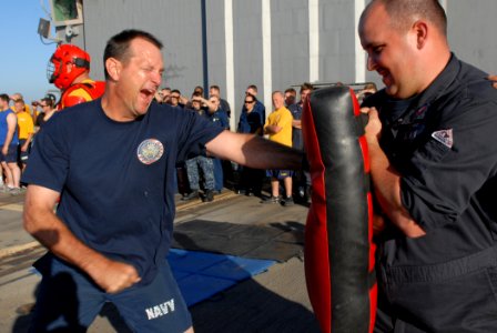 US Navy 111022-N-DU438-075 Master Chief Brent Tidwell, the command master chief aboard the guided-missile destroyer USS Gettysburg (CG 64) punches