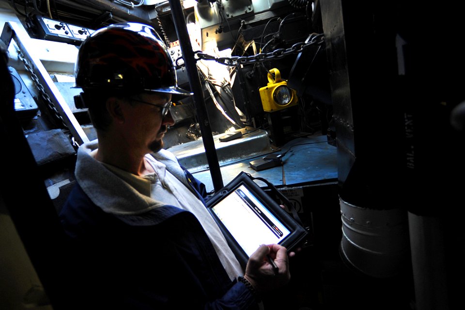 US Navy 111020-N-YR391-001 Todd Crawford, assessment director at Southeast Regional Maintenance Center, utilizes the REDI system tablet to conduct