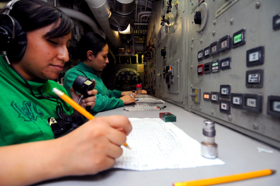 US Navy 111022-N-JD217-013 Aviation Boatswain's Mate (Equipment) 3rd Class Gerise L.M. Lojero, left, and Aviation Boatswain's Mate (Equipment) 3rd