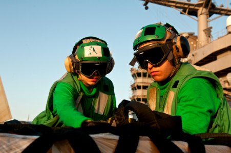 US Navy 111020-N-BT887-105 Logistics specialists unwrap cargo during a vertical replenishment