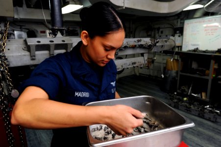 US Navy 111020-N-XE109-046 Aviation Ordnanceman Airman Melissa Madrid gathers parts before conducting maintenance aboard the aircraft carrier USS G