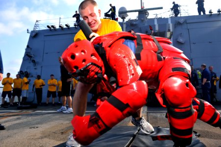 US Navy 111023-N-YZ751-020 Fire Controlman 3rd Class Adam B. McGinnis takes down a target after being sprayed with oleoresin capsicum (OC) during s